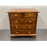 Apprentice miniature chest of 2 over 3 drawers in flame mahogany on bracket feet with brass handles.