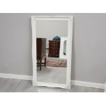 Swept bevelled mirror with painted white frame, 75x137cm