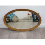 An early 20th century oval bevelled wall mirror 82cm wide.
