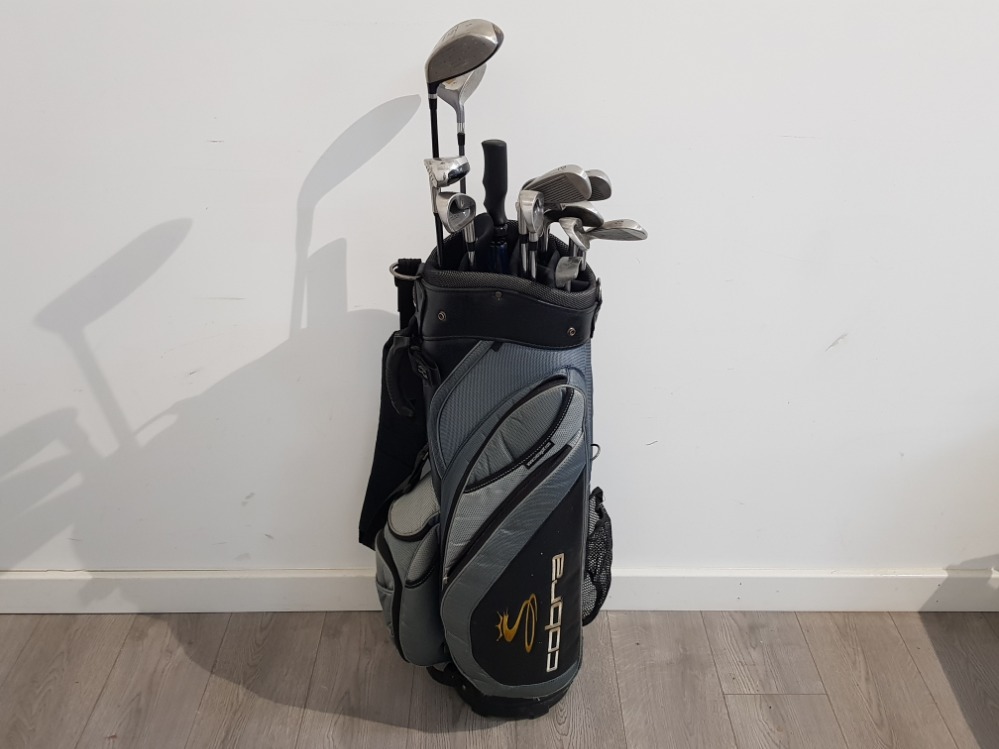 Cobra golf bag containing trilogy golf clubs and umbrella