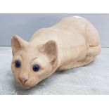 Heavy stone ornament, ready to pounce cat with distinctive blue eyes