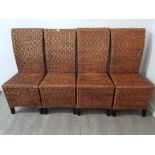 A set of four rattan dining chairs.