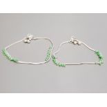 A pair of silver and green paste anklets 19.9g gross.