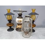 A pair of metal and amber glass oil lamps together with vintage metal lantern plus a table lamp