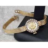 A Ladys 14ct yellow and white gold Oro diamond set bracelet wristwatch, bezel surround of 20 round