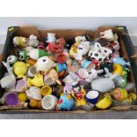 A large collection of novelty egg cups to include farm animals, soldier etc.