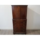 A reproduction mahogany veneer drinks cabinet 61 x 129.5 x 43cm.