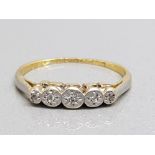 An 18ct yellow gold and platinum 5 stone diamond ring in illusion setting, size M, 1.9g gross.