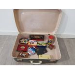 Vintage cigarette tins and money boxes in a suitcase.