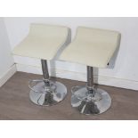 Pair of metal framed pedestal breakfast bar stools with cream leatherette seats