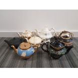 a box containing 8 teapots includes ringtons etc