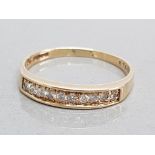 9k yellow gold channel set diamond ring, size N, 1.6g gross