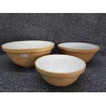 Three ceramic mixing bowls of various sizes.