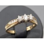 Ladies 9ct yellow gold diamond ring with 3 round brilliant cut diamonds in the centre and 3 more