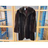 A ladies faux fur half length coat, size medium.