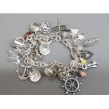 Silver plated charm bracelet, 25 charms in total