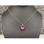 Ladies 9ct gold pendant and chain featuring a pink stone. 6.4g