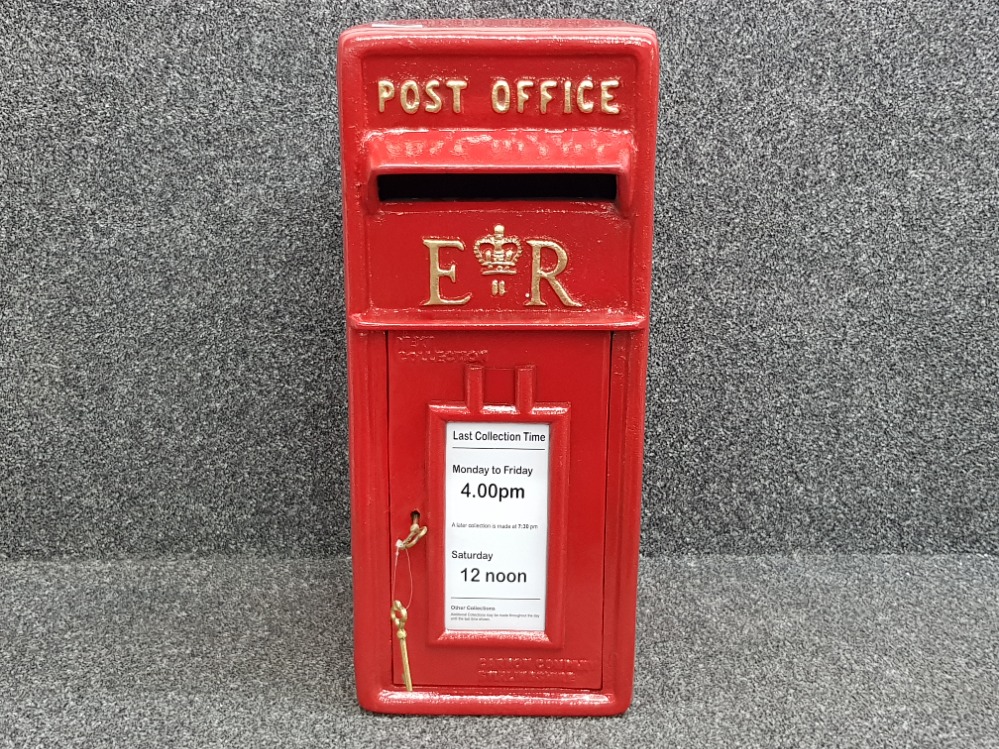 Large cast metal post office box in red, with keys