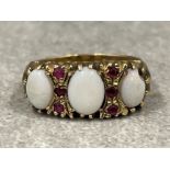 Ladies 9ct gold Opal and Ruby ring. Featuring 3 oval shaped Opals set with 6 round Ruby stones. Size