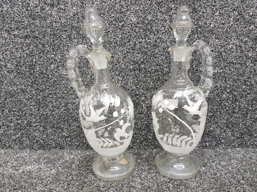 A pair of Victorian glass claret jugs with enamelled decoration 31cm high.