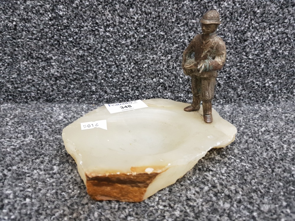 An onyx ashtray with cold painted bronze figure of a fisherman.