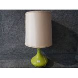 A green glass table lamp with cream shade 72cm overall height.