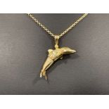9ct gold Dolphin pendant and chain. Dolphin set with Blue and White CZ stones. 20.5G