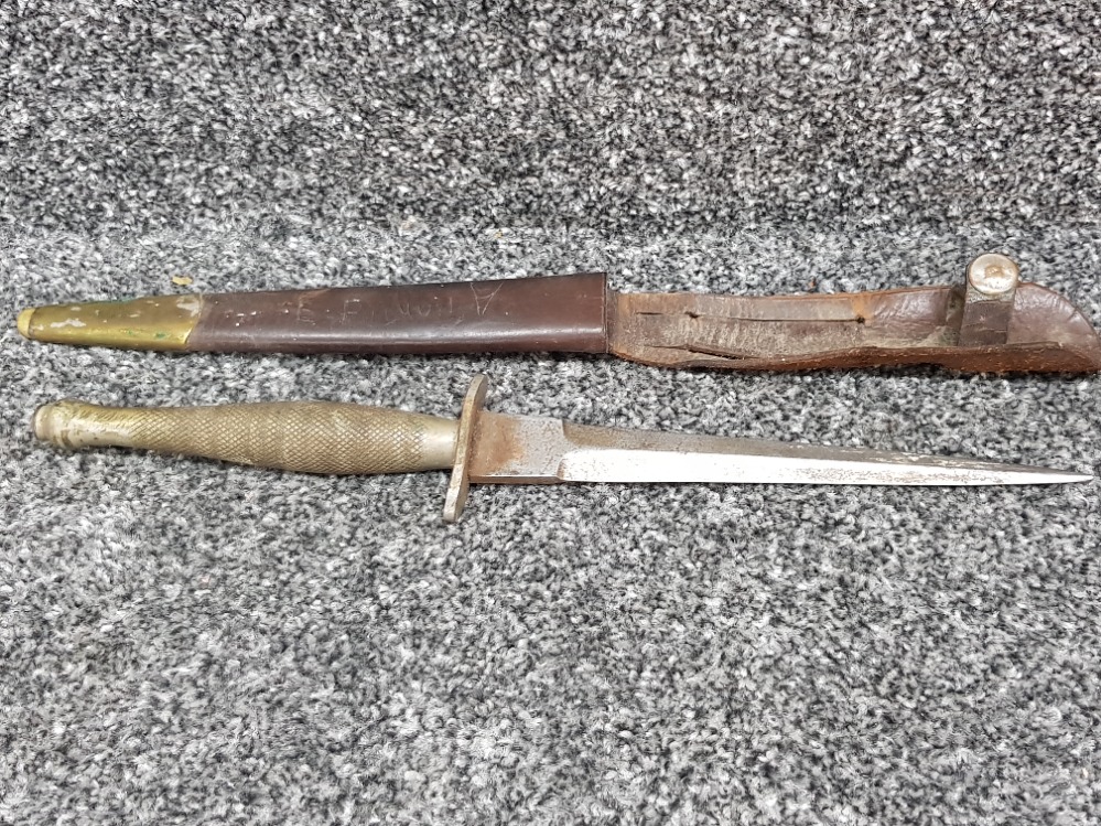 An antique continental dagger (30cm long) with leather and brass scabbard.