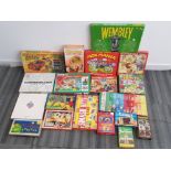Box containing 19 vintage games including Matchbox crash, Wembley and Mickey Mouse marble jump