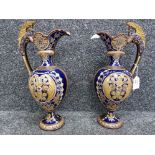 A pair of late 19th century German etruscan style ceramic ewers (damage) marks to base 36cm high.