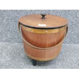 A vintage circular teak work box with contents 34cm high.