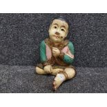 Hand painted wooden figure of an Asian child with applied decoration 32cm high.