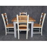 A Kitchen table and four matching chairs.