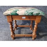 A pine stool with barley twist supports upholstered in hunting scene material.
