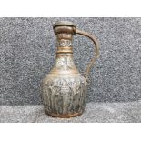 Persian style copper jug with embossed decoration of religious figures 31cm