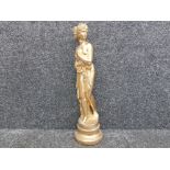 A gold painted plaster figure of a grecian maiden, raised on circular base 65cm high.