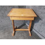 A pine school desk opening to reveal storage.