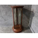 A cylindrical glass and laminate display cabinet 39 x 88.5cm.