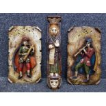 A pair of hand carved and painted wooden wall plaques depicting medieval musicians 51 x 29cm, and