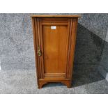 An Edwardian oak bedside cupboard with laid on prints to top 18 x 70.5 x 37cm.