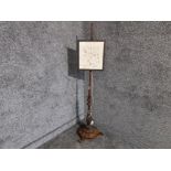 Antique pole screen with added needlework top and fitted with light.