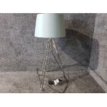 Industrial style floor lamp with blue shade.