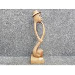 Tall African wood carving of the pipe smoker