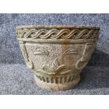 A composite stone garden planter 34cm diameter.