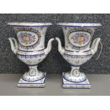 Pair of porcelain floral Patterned twin handled urns, De La Reine, height 26cm