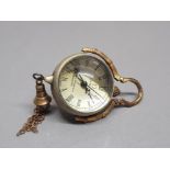 A miniature brass omega desk ball clock