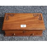 An Indian wooden desk tidy with carved decoration 31cm wide.