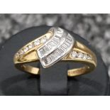 Ladies 18ct gold Diamond ring. Comprising of BAGUETTE diamonds set in the centre with round