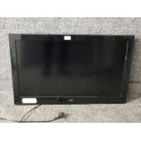 A 32" Logik flatscreen TV with wall mount fitting.