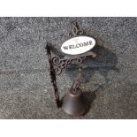 A reproduction cast metal outside wall hanging Welcome bell.